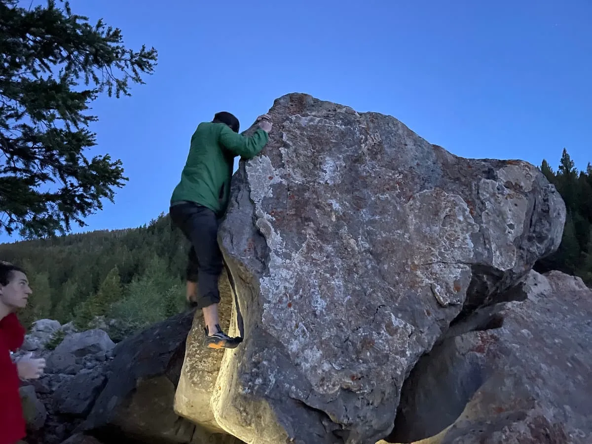 Trevor getting the first ascent on a cool boulder as 18 year old whole foods employee looks on